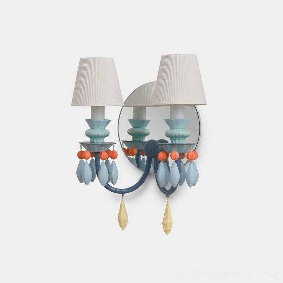 Cielora dual ceramic bead wall sconce with pleated fabric shades in pastel blue color, frontal studio view against white background