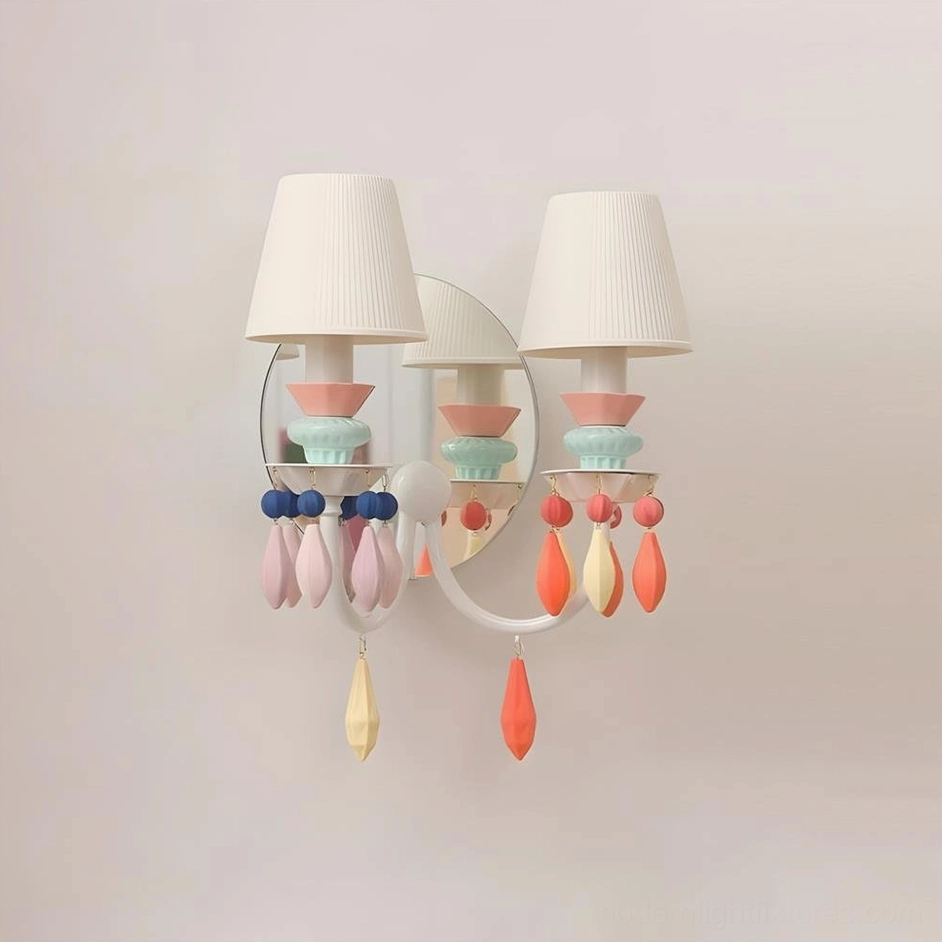 Cielora dual-arm wall sconce in macaron multi-color pastel palette with curved white metal frame and pink-blue ceramic accents