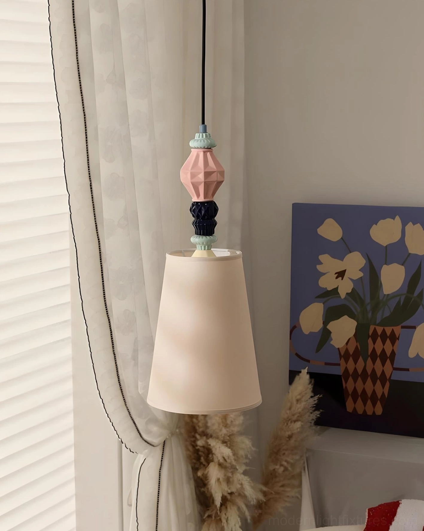 Pastel geometric ceramic totem pendant light with off-white conical shade in modern minimalist corner space with artwork