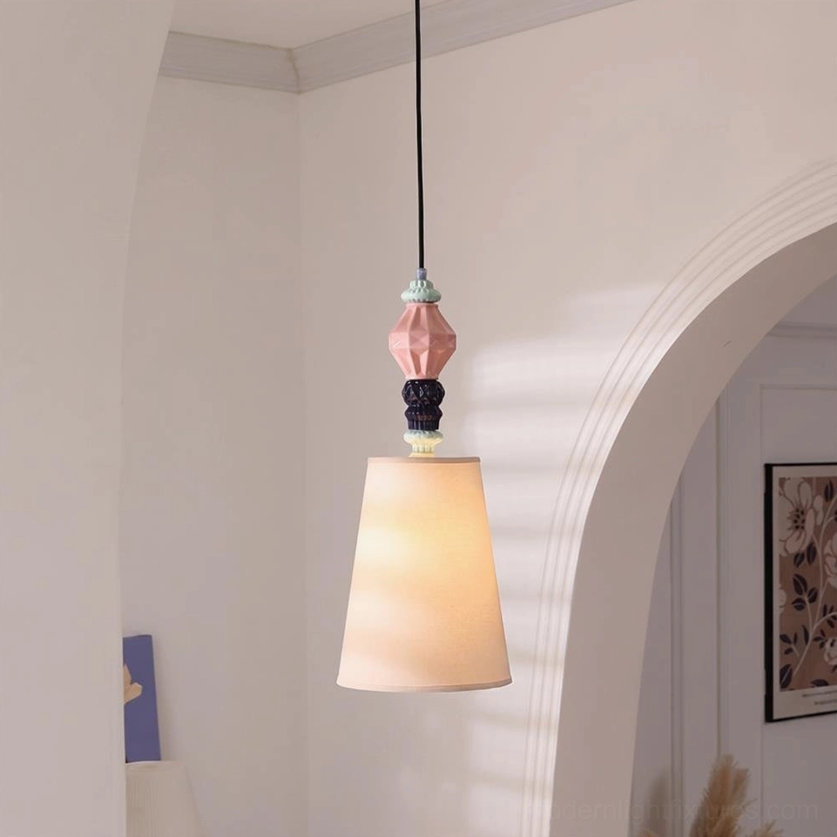 Off-white conical fabric shade pastel geometric ceramic totem pendant light in white arched residential space, minimalist bohemian