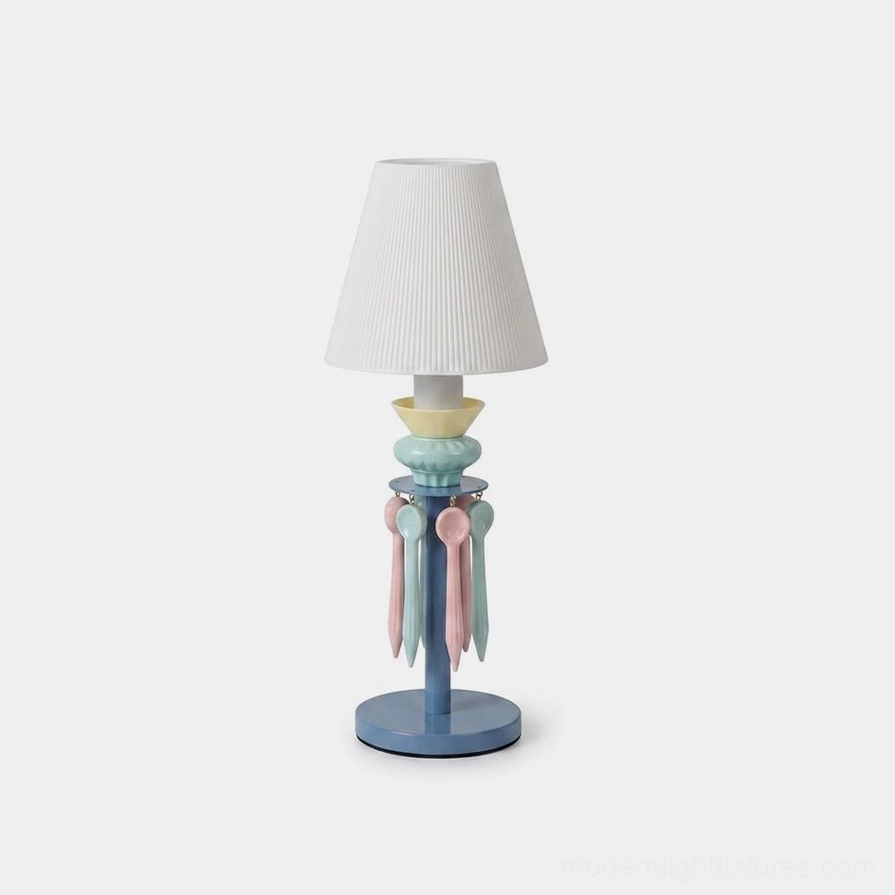 Cielora pastel tassel table lamp with pleated fabric shade and ceramic base featuring hand-finished decorative tassel accents, front studio view