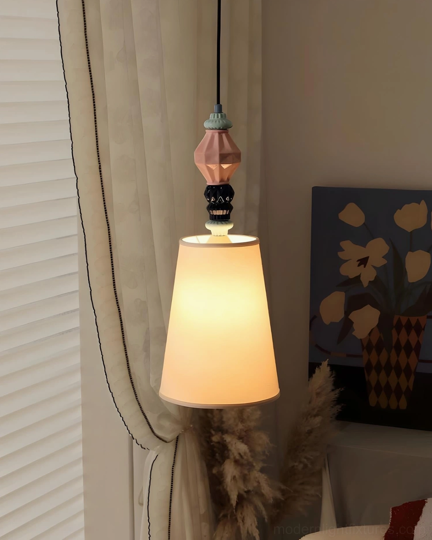 Cielora modern pendant light creating warm ambient glow over reading nook, soft-diffusion fabric shade