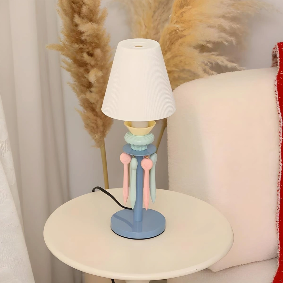 Cielora pink and blue tassel table lamp variant with pleated shade and decorative ceramic metal base on display