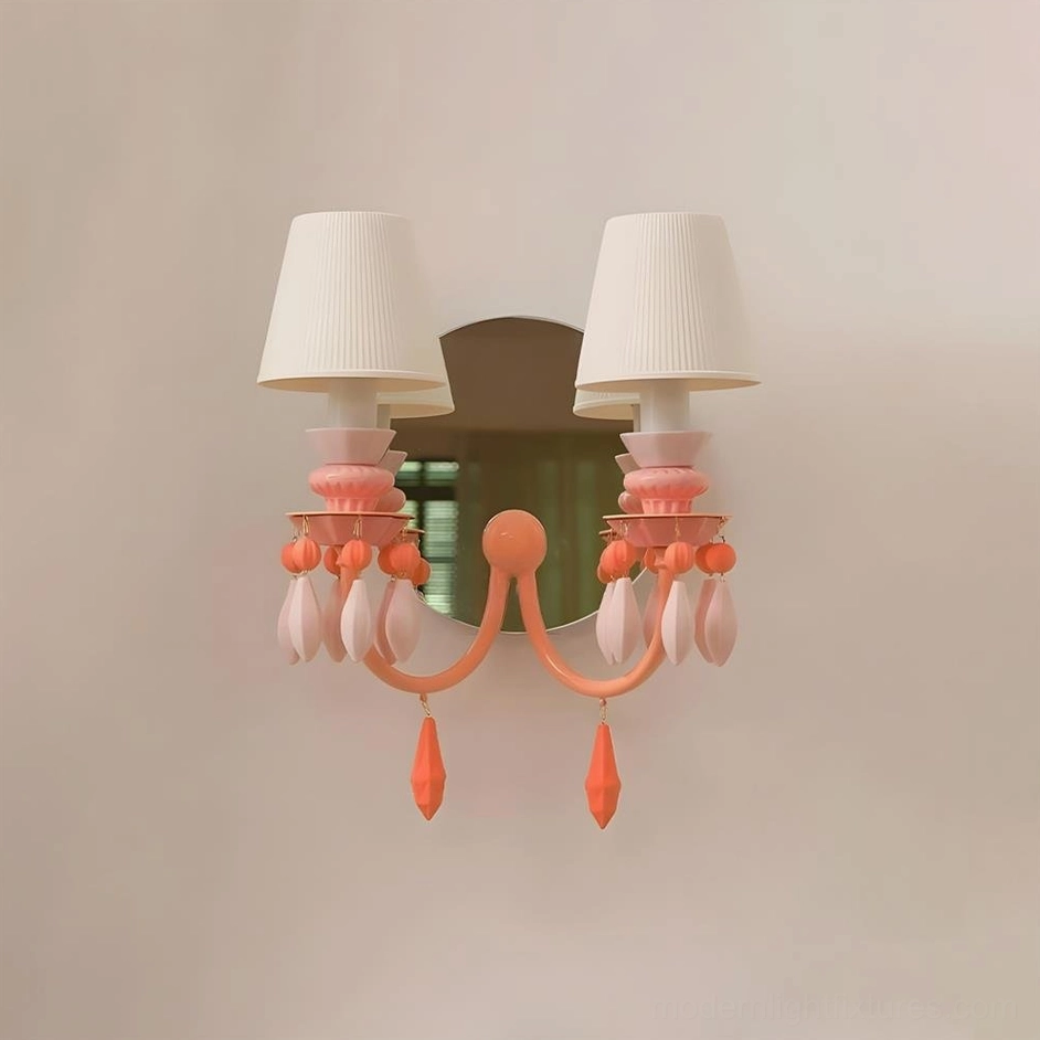 Cielora pink wall-mounted sconce with teardrop ceramic pendants and dark mirror backplate on neutral beige wall