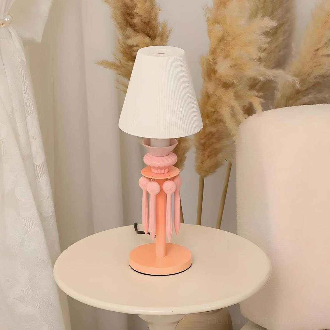 Cielora pink pastel tassel table lamp on side table in contemporary bohemian style living space