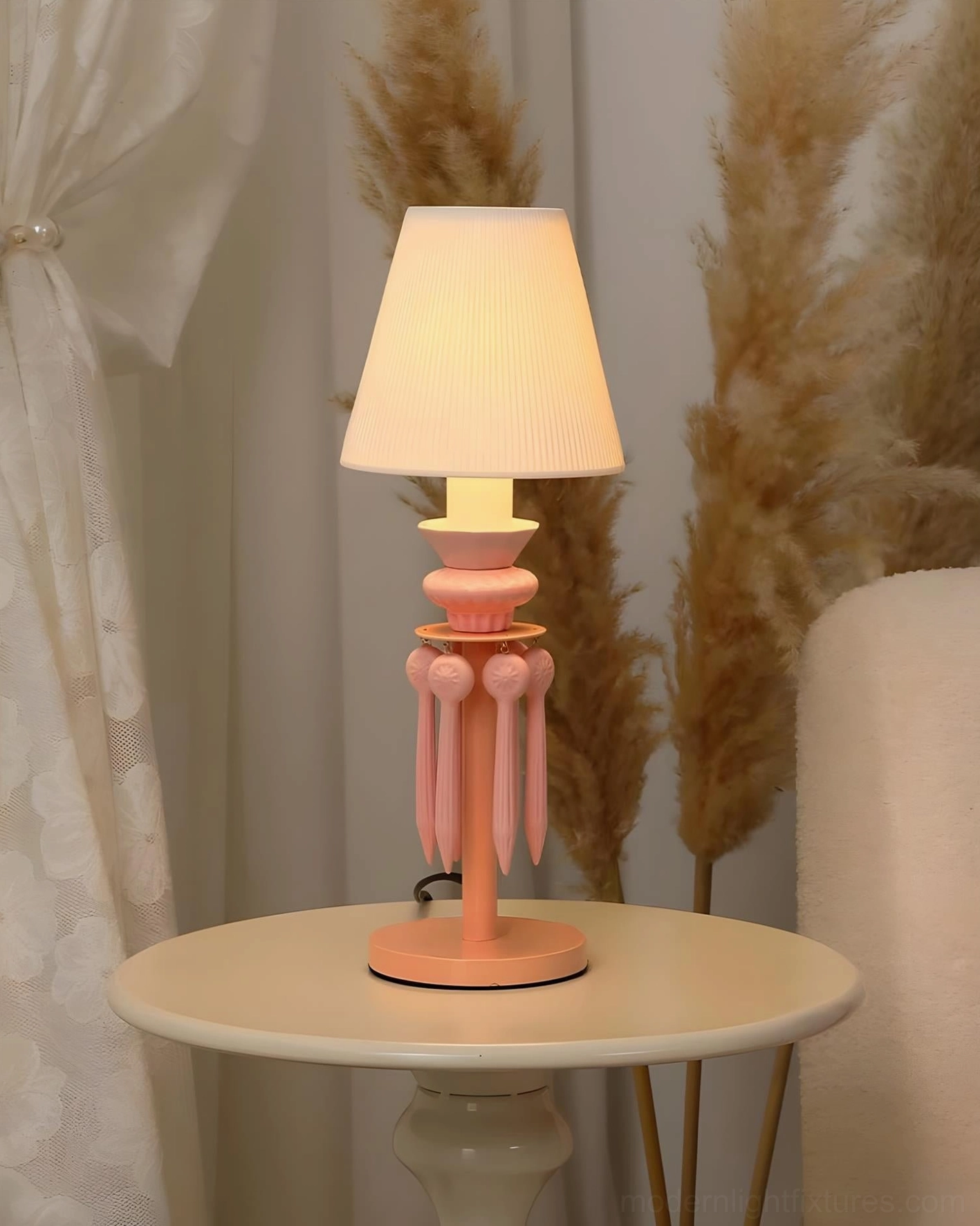 Cielora pink tassel table lamp creating warm ambient lighting in home interior design arrangement