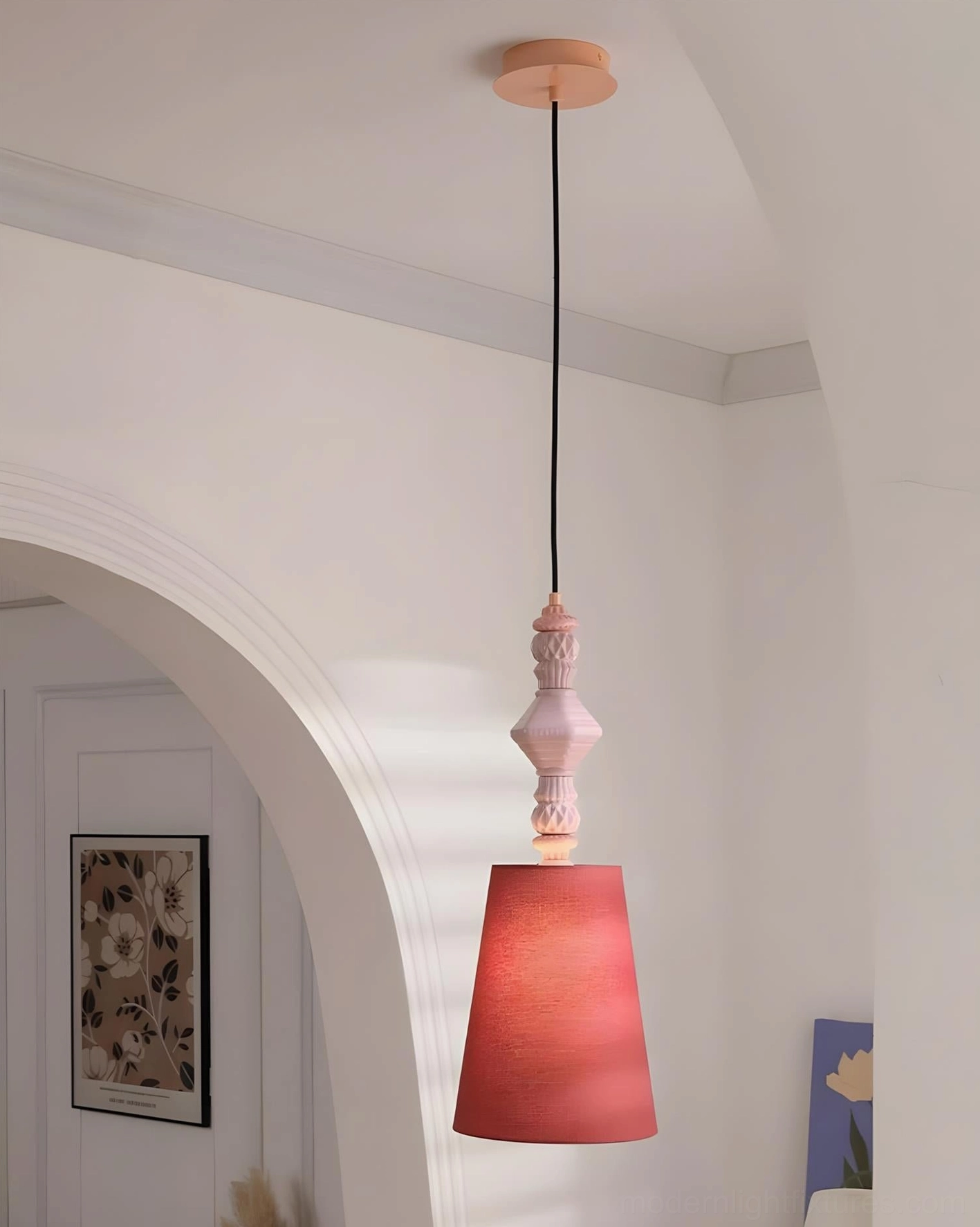 Dark red tapered shade ceramic totem pendant light in white arched residential hallway, simple bohemian decor