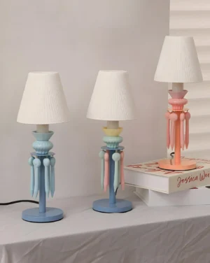 Set of three Cielora tassel table lamps in pink and blue pastel colors displayed on tabletop, high angle product showcase