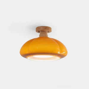 Cipola mushroom ceiling light with warm orange glass shade and solid wood base, front view on white background
