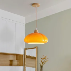 Warm orange Cipola mushroom pendant light glowing in residential dining room, side angle view