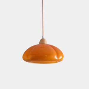 Cipola warm orange pumpkin-shaped pendant lamp with glass dome shade and wooden top cap, front studio view