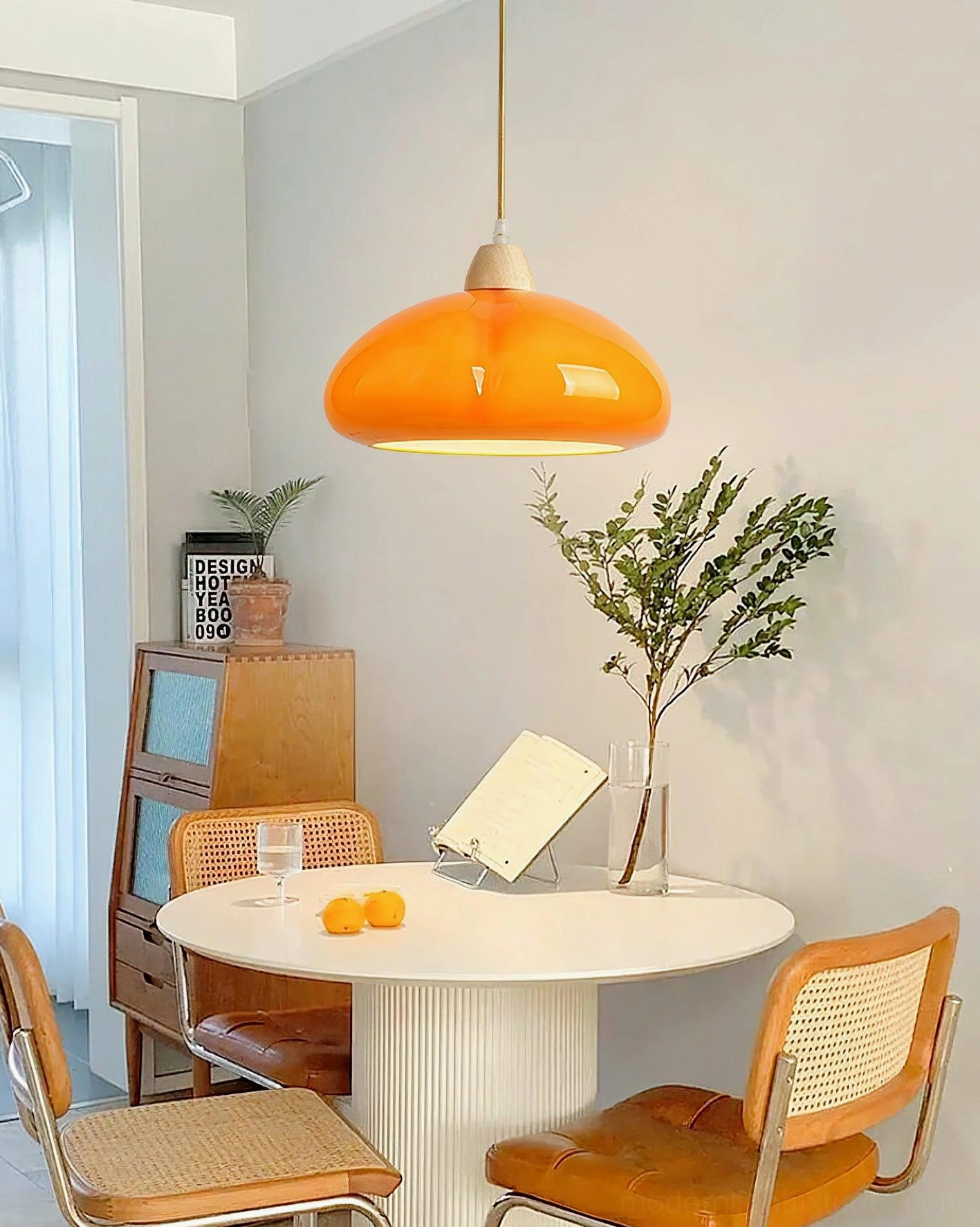 Cipola pumpkin pendant lamp installed in cozy small apartment dining nook with retro warm decor