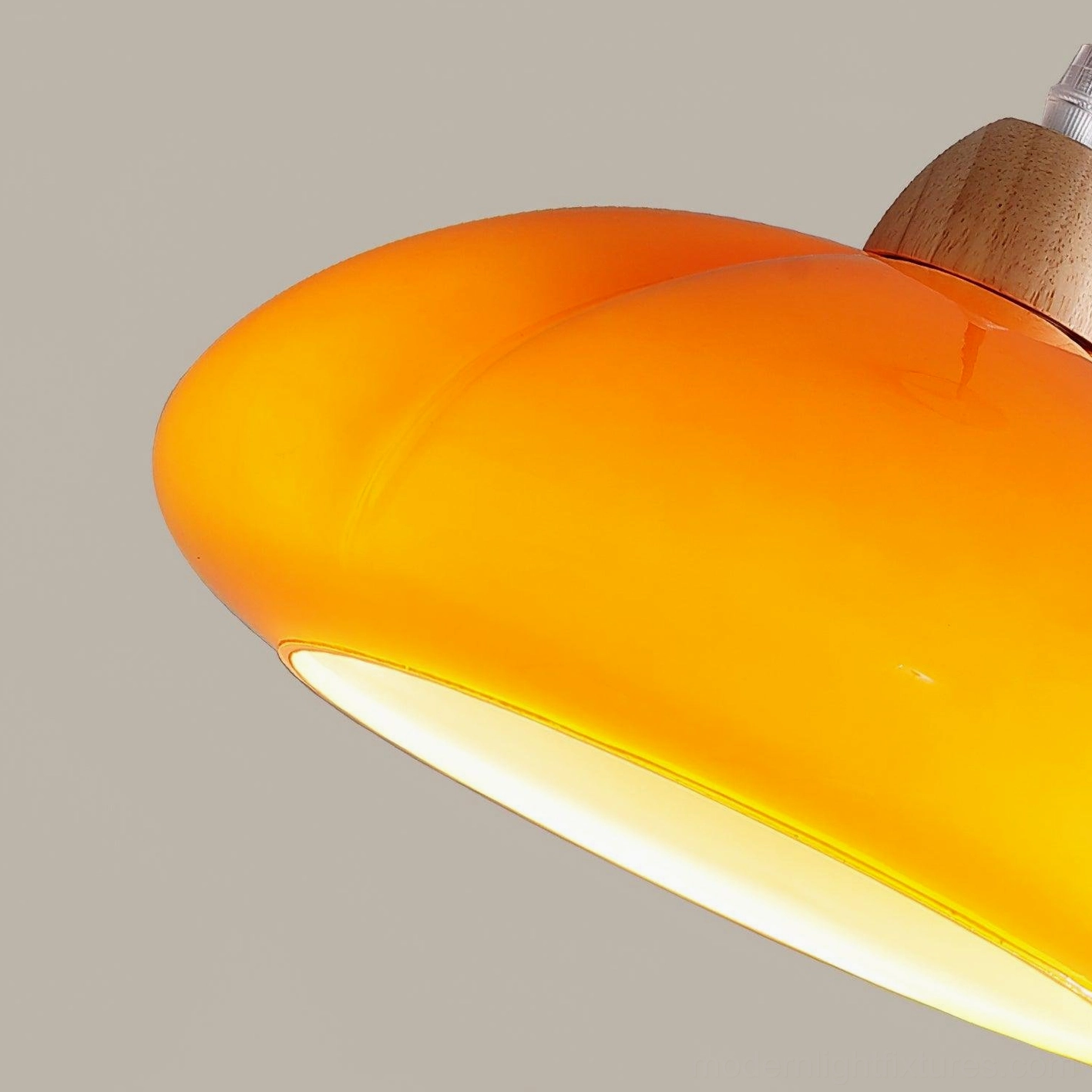 Cipola pumpkin pendant lamp installed in sloped ceiling dining room area
