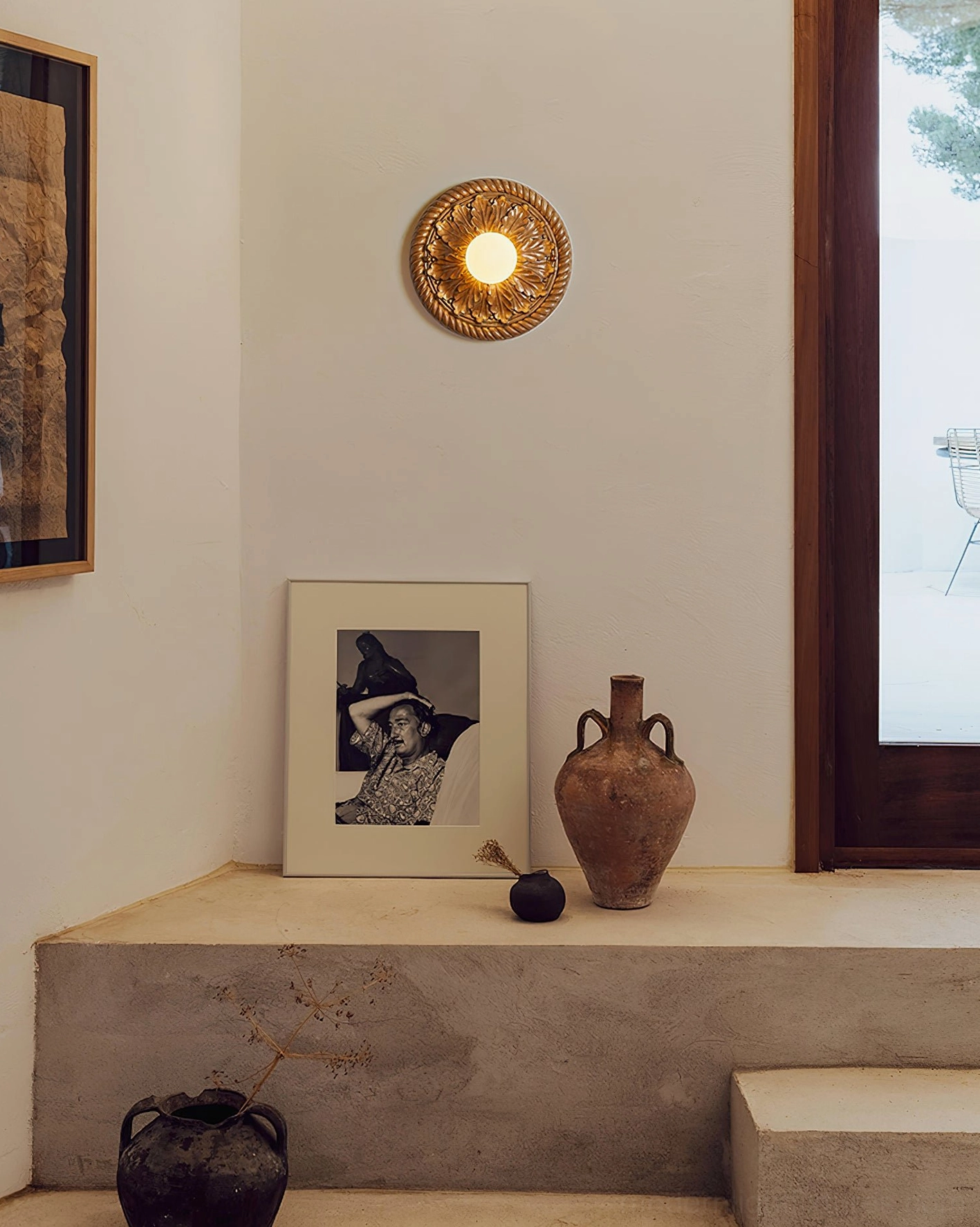 Circa black bronze ceiling light fixture installed in vintage entry hallway nook, warm ambient glow