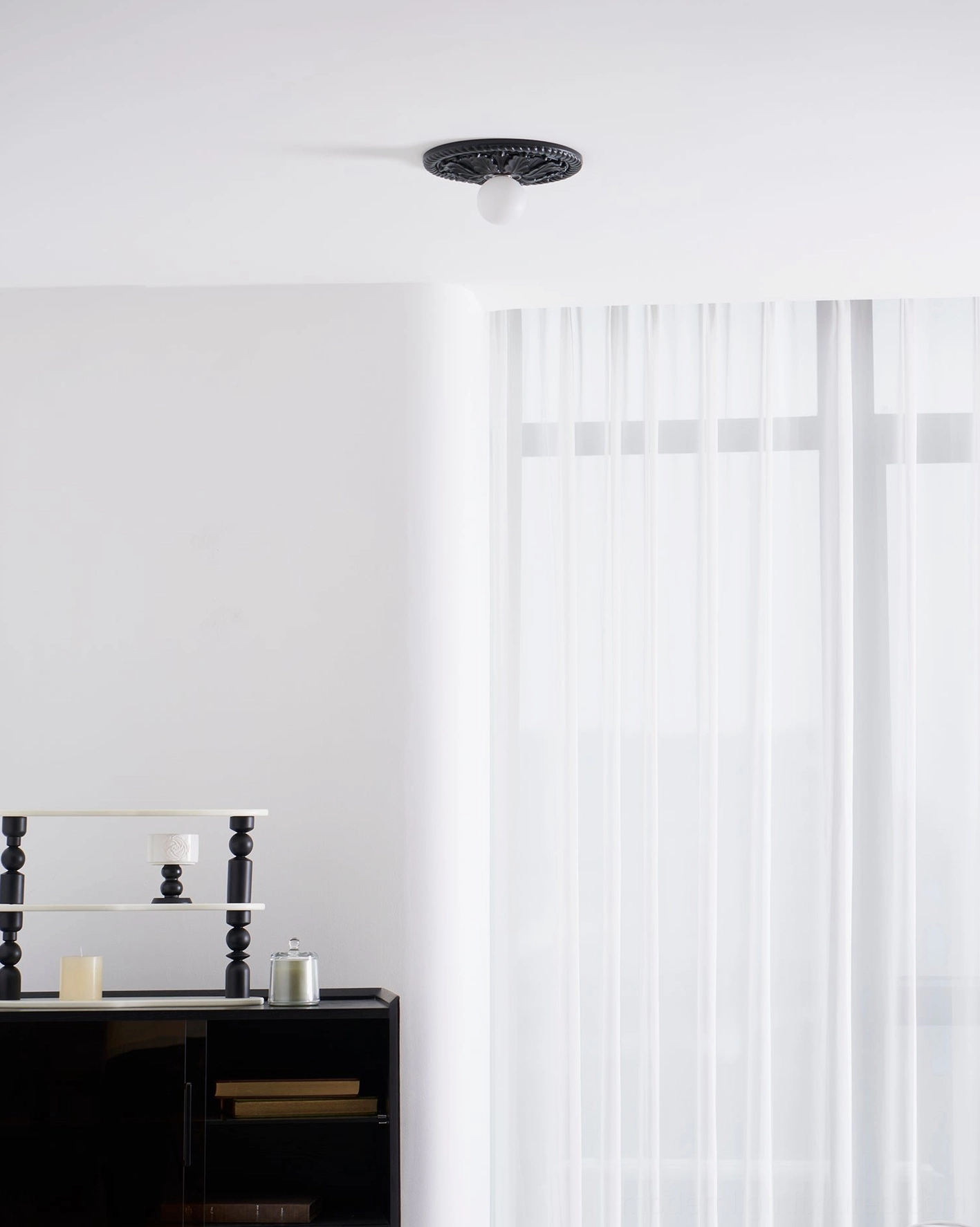 Circa black ceiling light fixture in traditional bedroom setting with warm ambient lighting