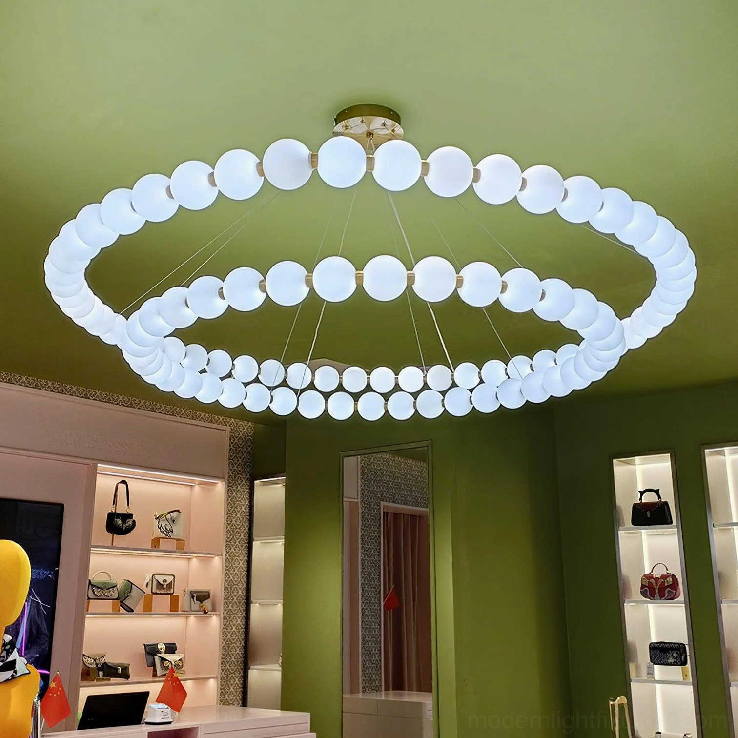 Minimalist luxury circular ring pearl chandelier upward ceiling view with brass mounting hardware