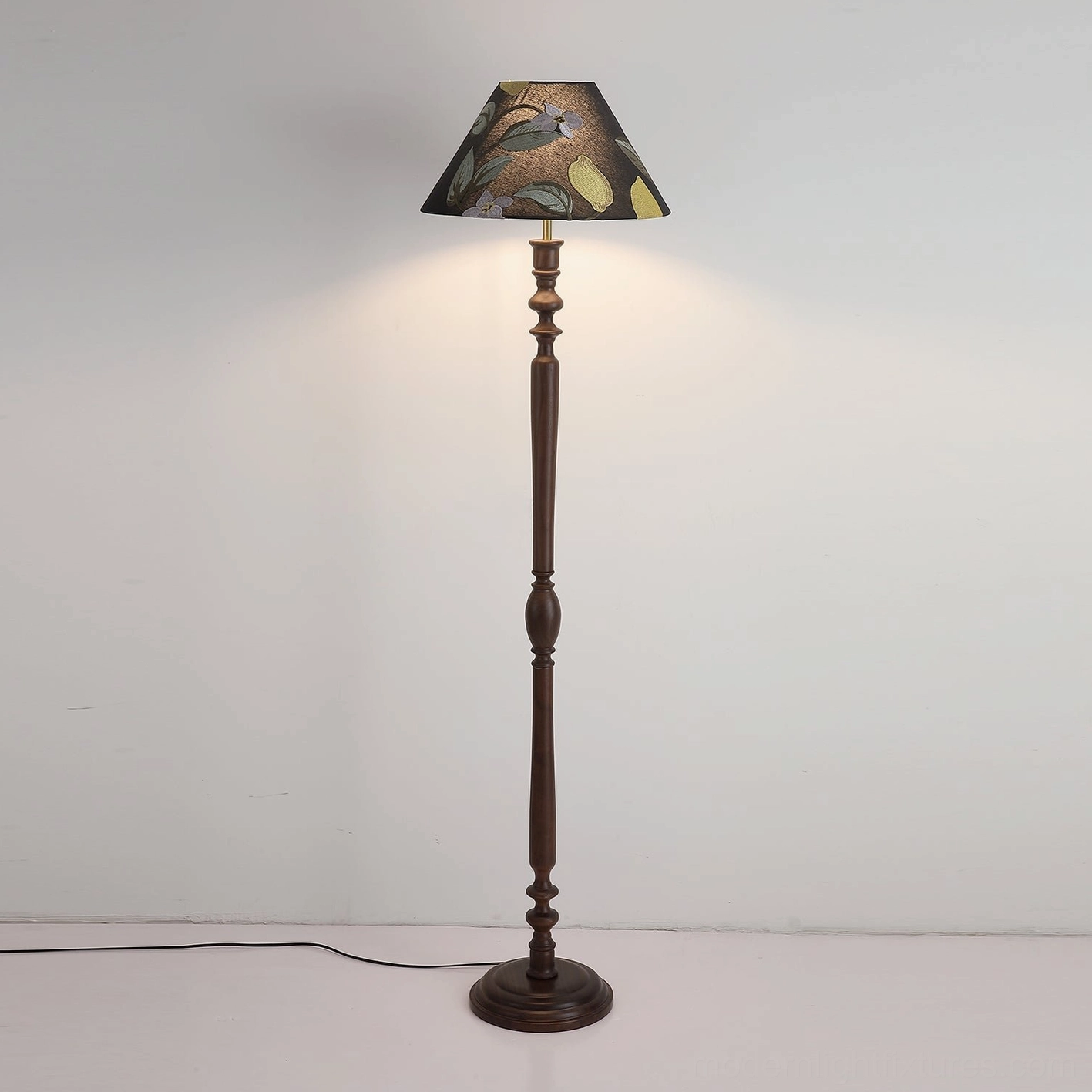 Illuminated Citrina floor lamp in interior setting emitting warm ambient light