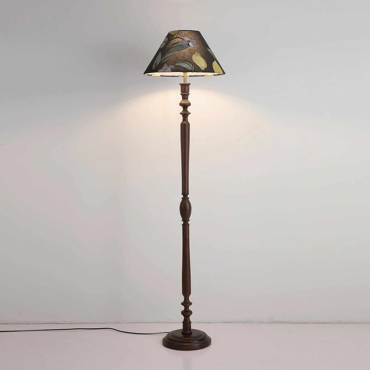Citrina floor lamp casting warm glow in corner interior room setting