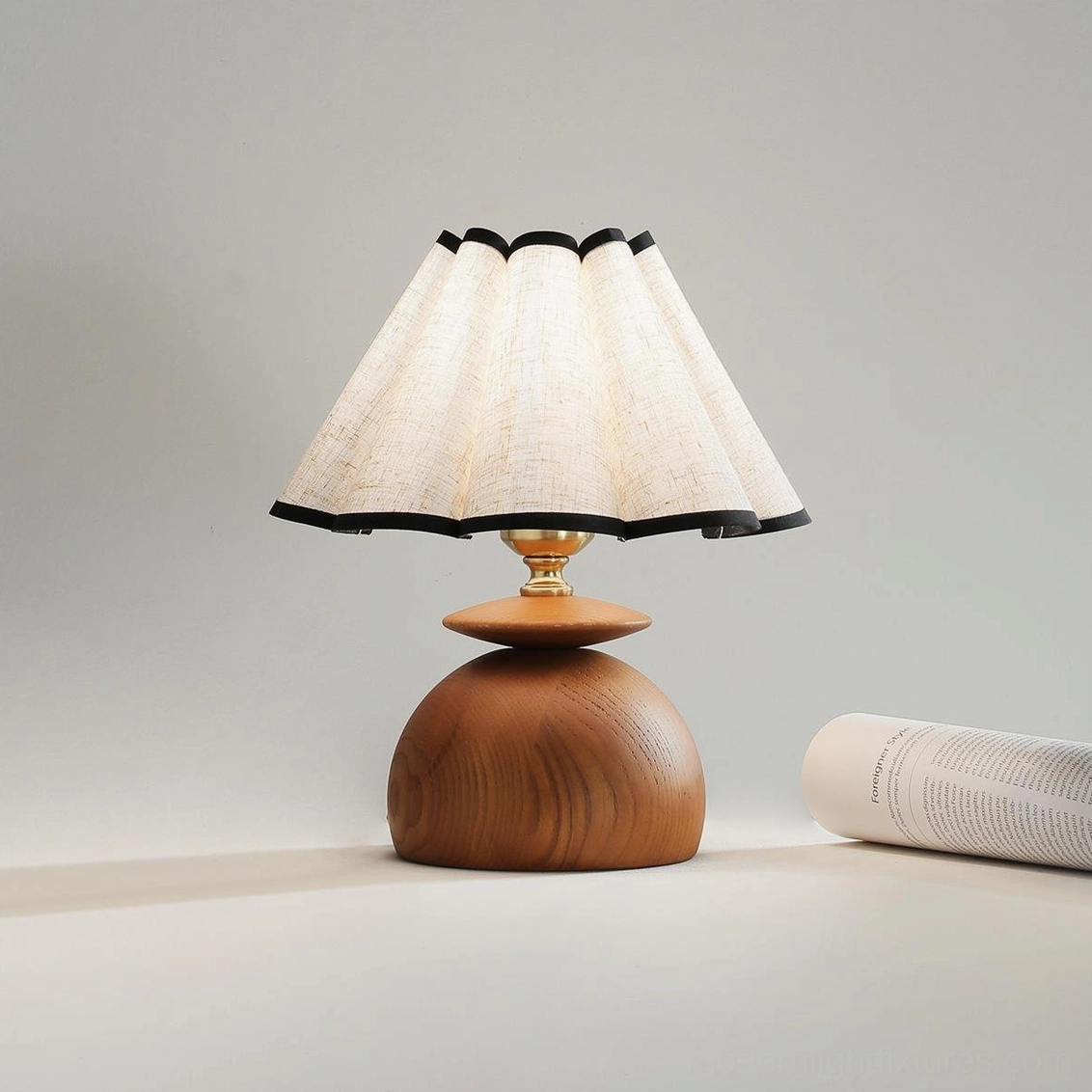 Pleated black-trimmed fabric dome table lamp with gold metal fixtures and stacked walnut wood base