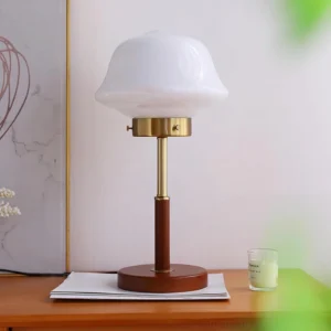 Clara wooden table lamp detail showing three-quarter side angle with brass hardware and warm brown wood grain