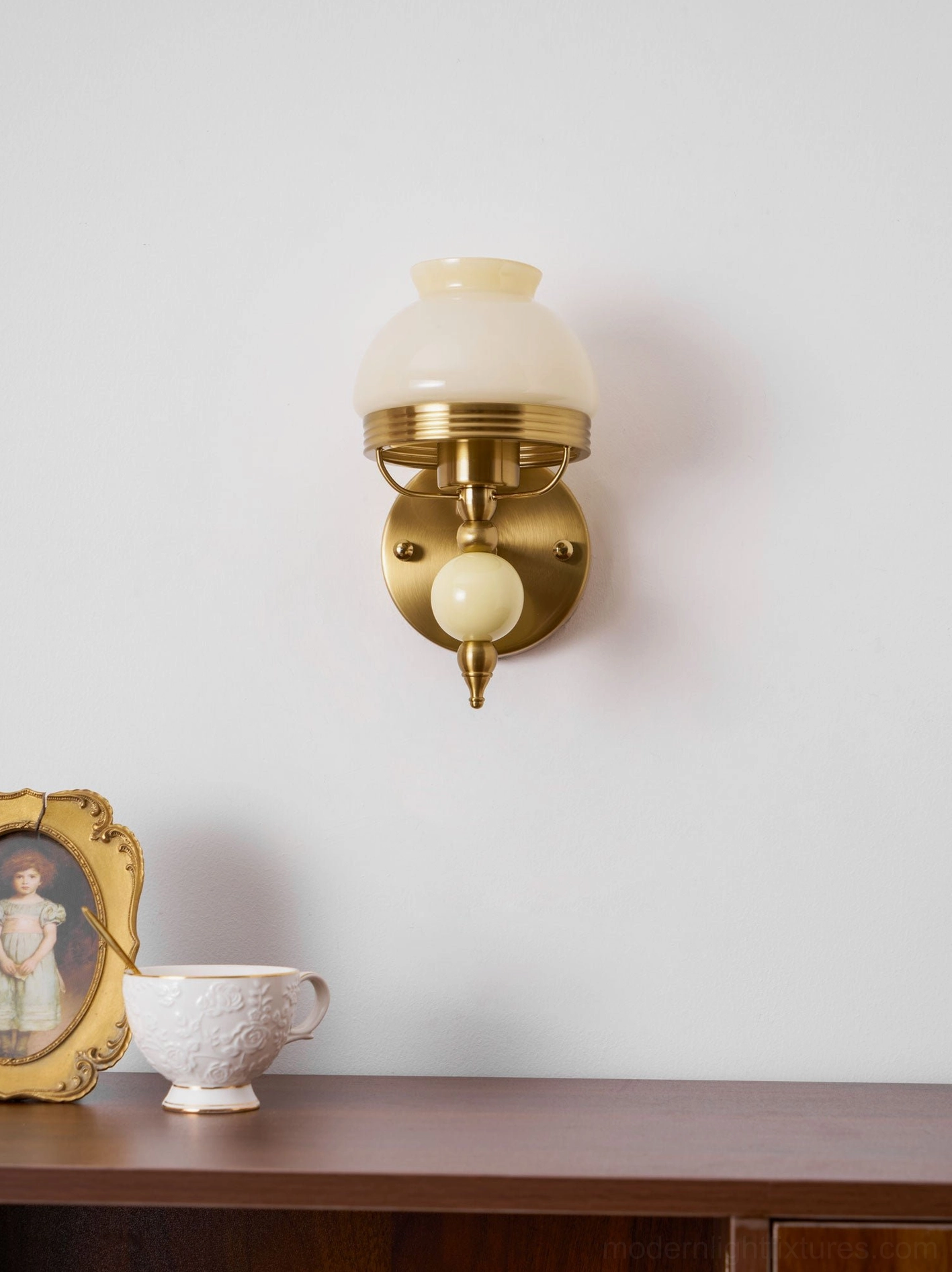 Classic retro wall lamp showing frosted glass shade with floral motif in soft lighting