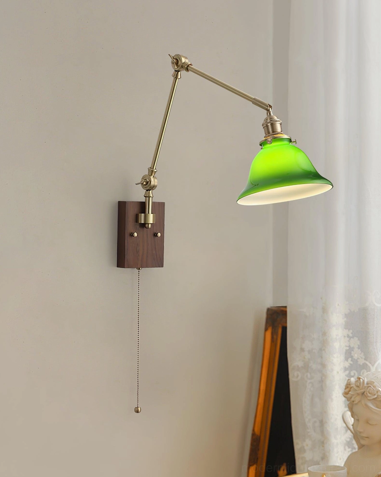 Swing arm wall sconce in classic vintage design with green glass dome, brass hardware, and walnut wood base for industrial and mid-century modern interiors