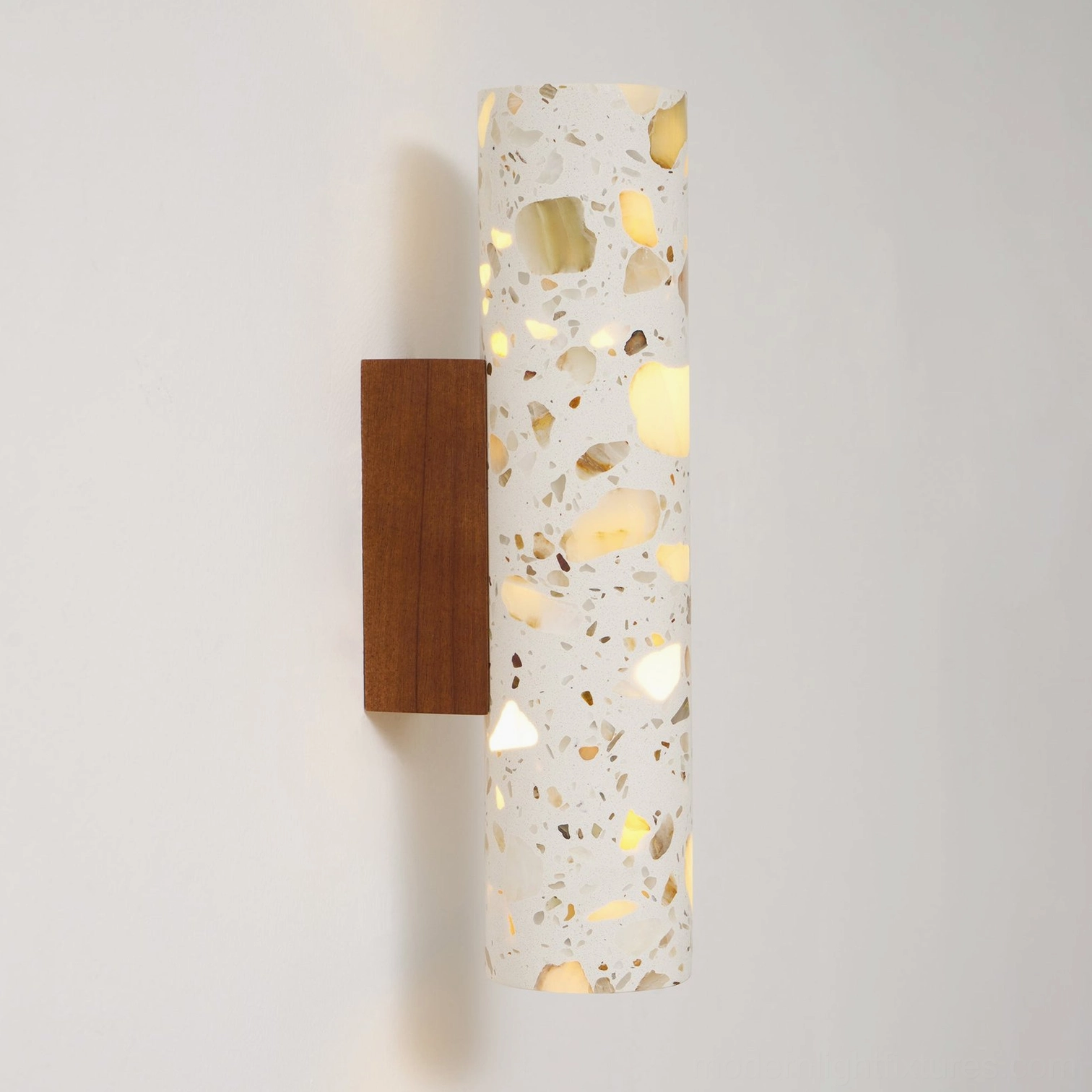 Close-up detail of Clasten terrazzo wall sconce showing natural stone aggregate and cement matrix texture