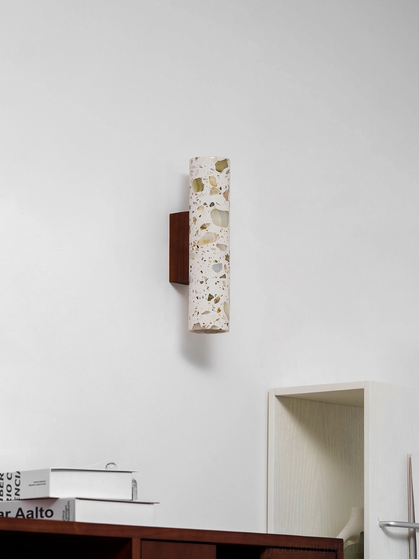 Terrazzo wall sconce showing natural light interaction with stone texture throughout day