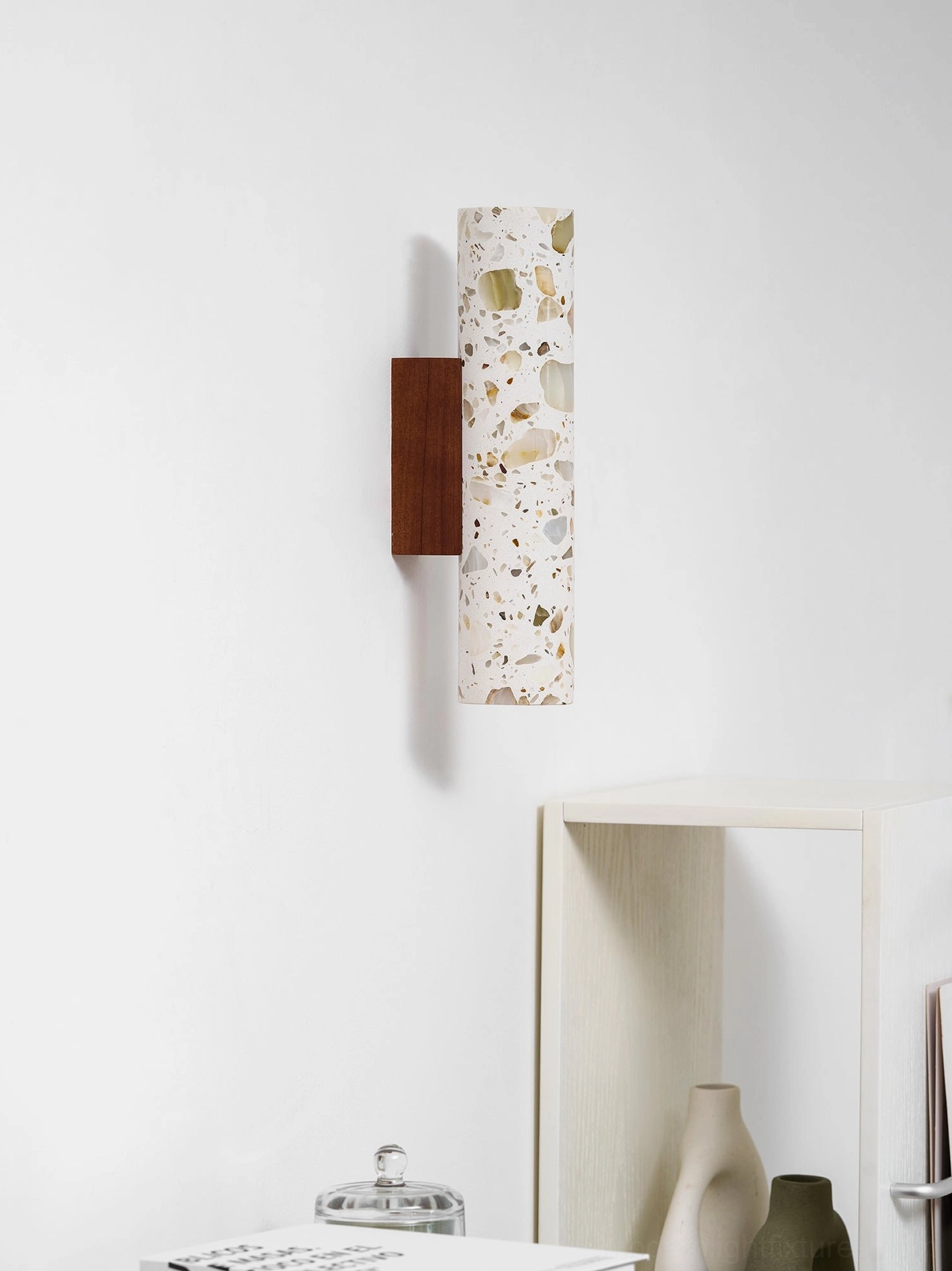 Contemporary terrazzo wall lamp mounted in hallway gallery setting with multiple installations