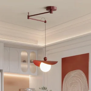 Wine red swing arm pendant light installed over dining table in cream-colored dining room with frosted spherical bulb