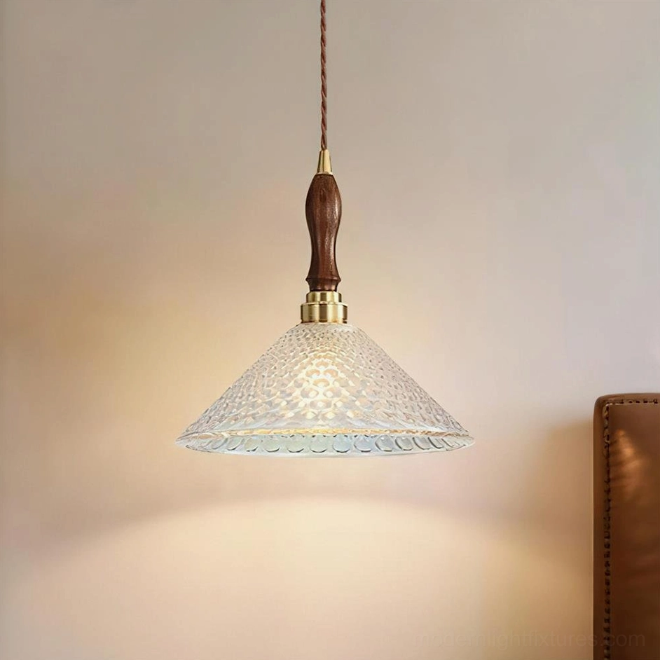 Clear embossed conical glass pendant lamp with warm lighting and minimalist vintage design aesthetic