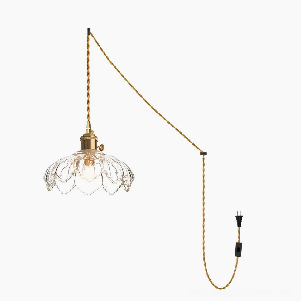 Clear scalloped fluted glass shade on pendant light with twisted fabric power cord overhead view