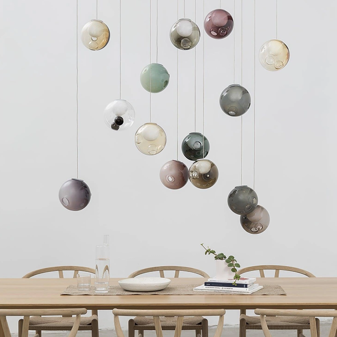 Hand-blown clear glass globe cluster pendant demonstrating light refraction and ethereal illumination qualities