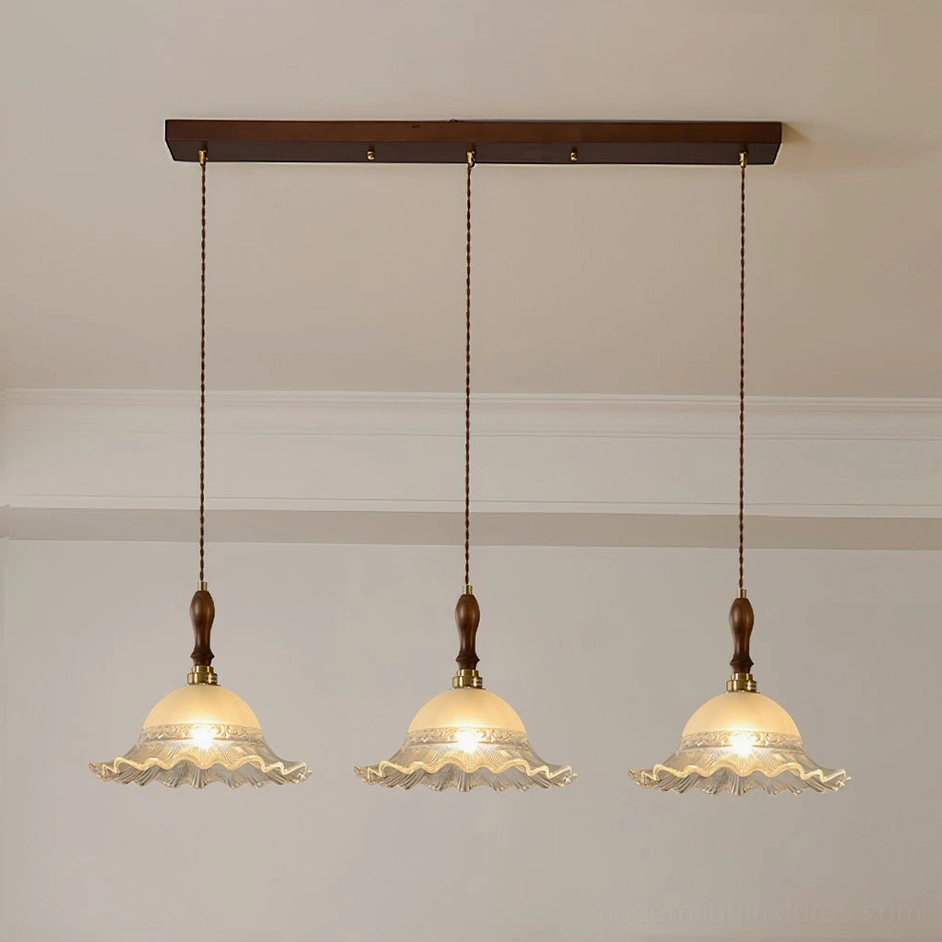 Clear hand-blown frosted glass pendant light with embossed pattern and brass hardware