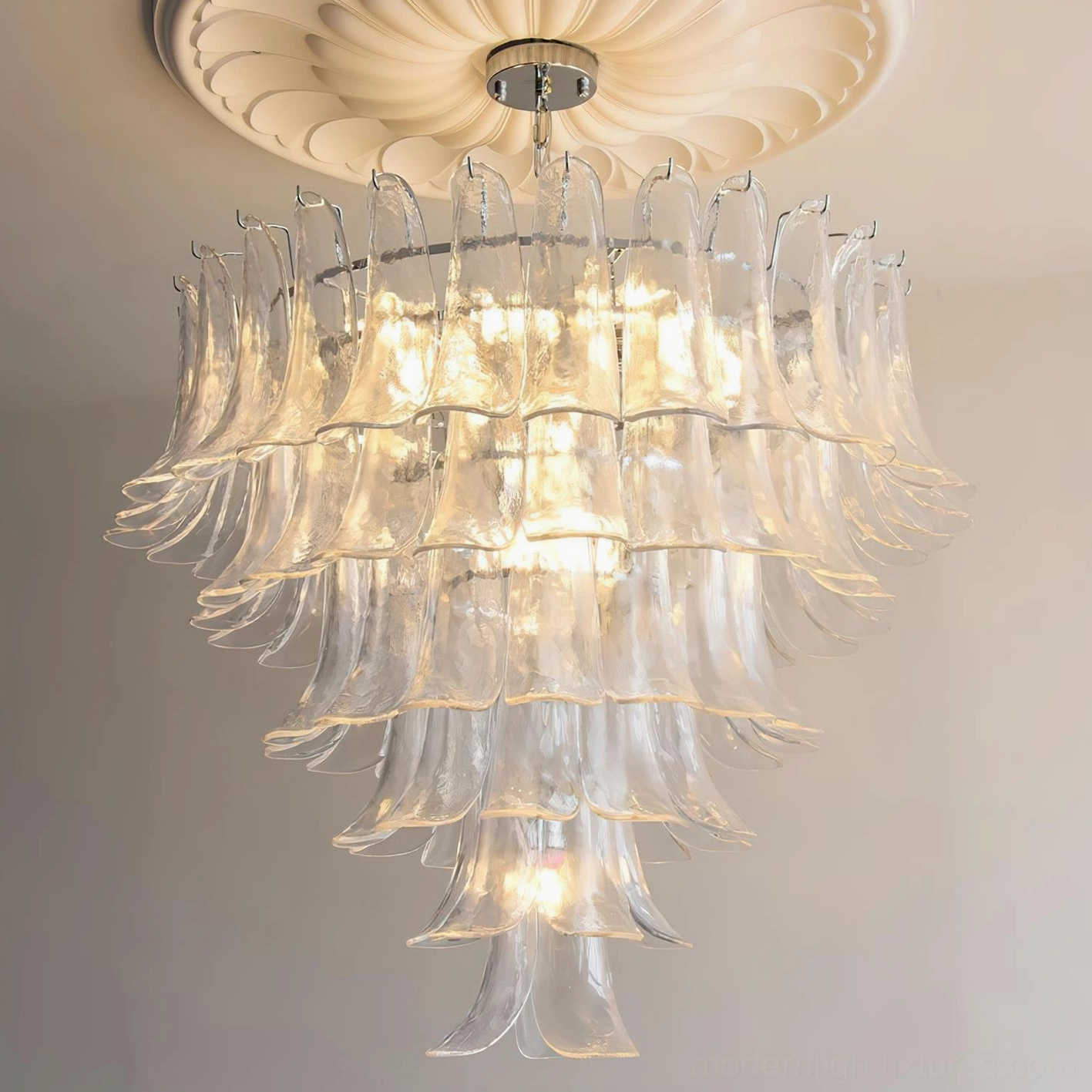 Petal chandelier with clear glass creating luminous sculptural effect in modern bedroom space