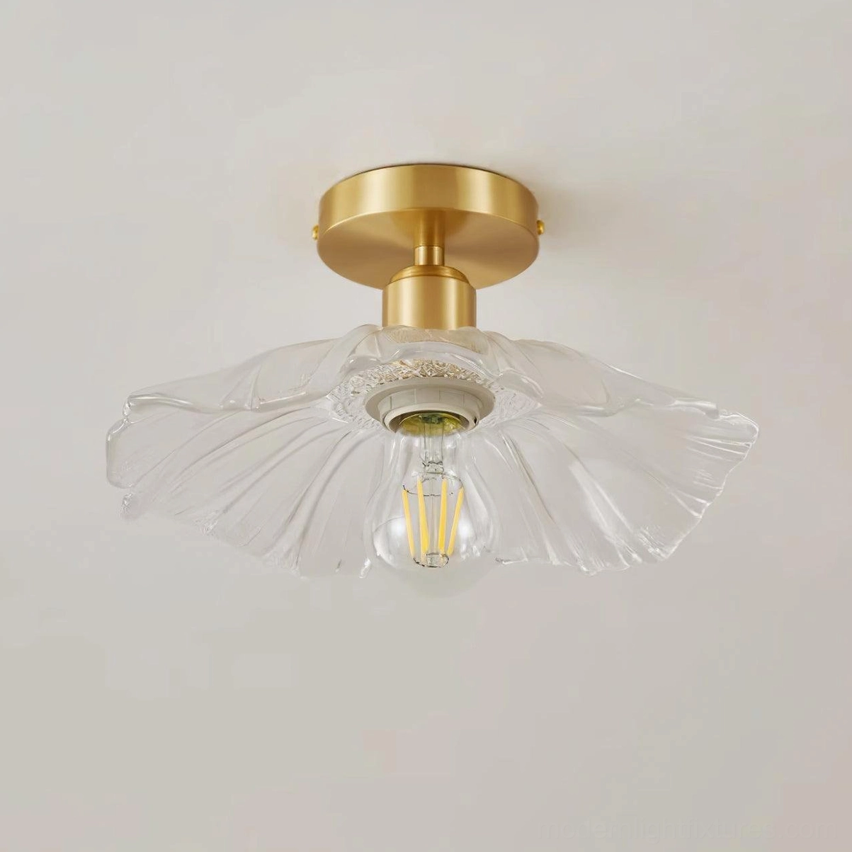 Clear textured ruffled glass shade of semi-flush ceiling light fixture showing intricate fluted design pattern