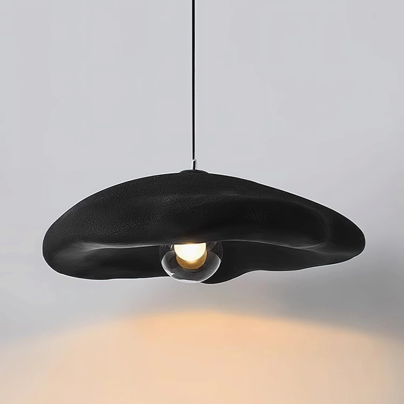 Contemporary cloud pendant light - warm ambient glow beneath sculptural shade