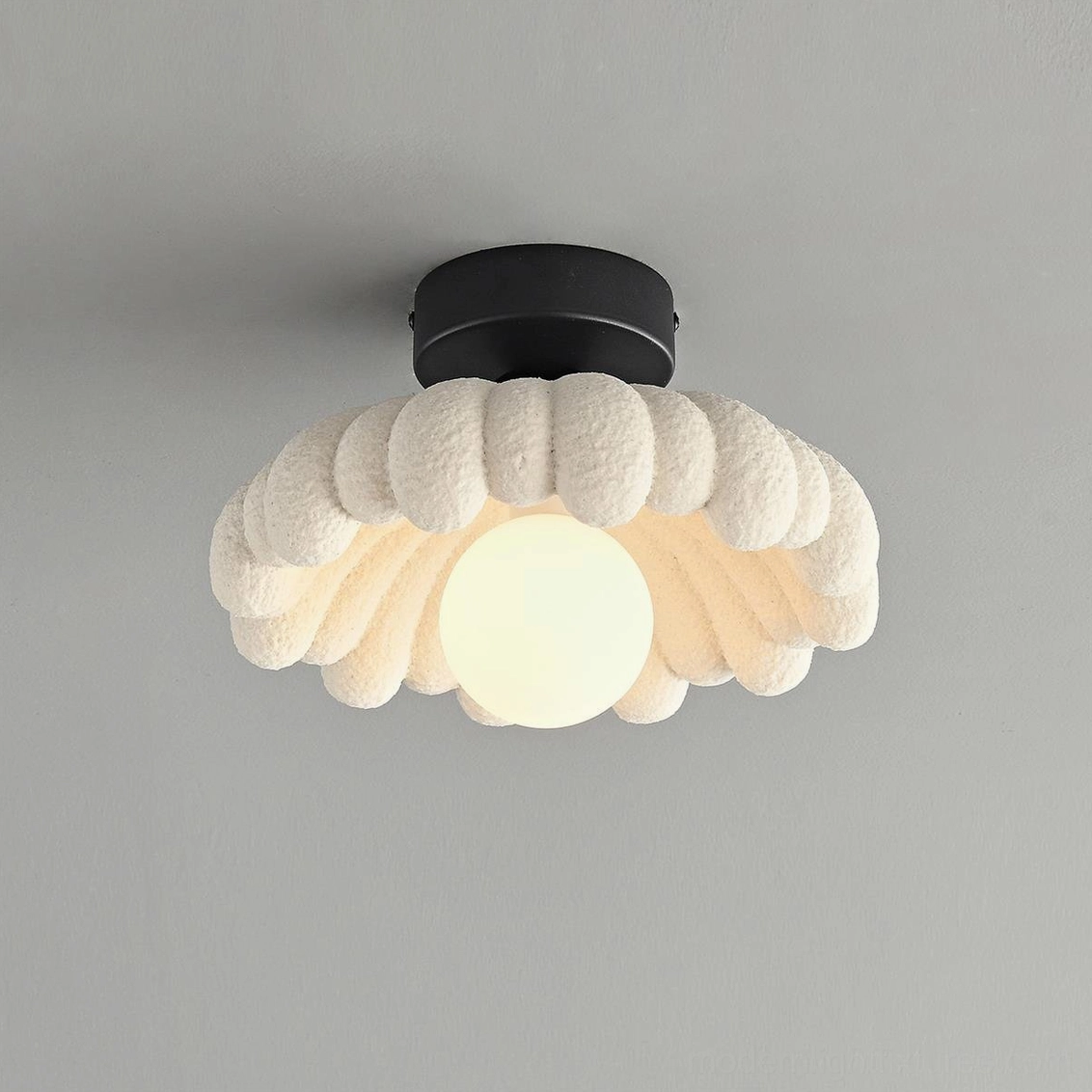 Cloud Petal sculptural ceiling light fixture with frosted glass globe and plush resin shade on gray background