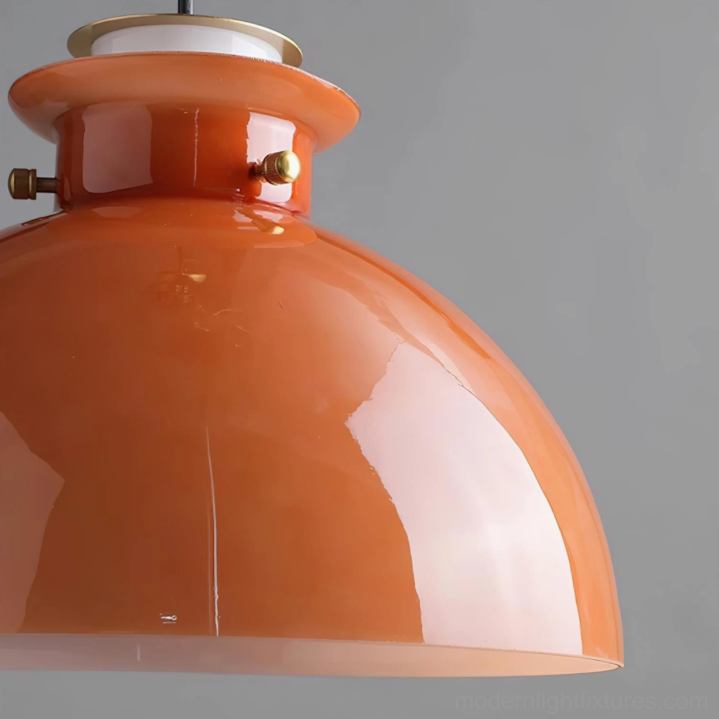 Multiple orange dome pendant lights arranged for layered ambient and task lighting