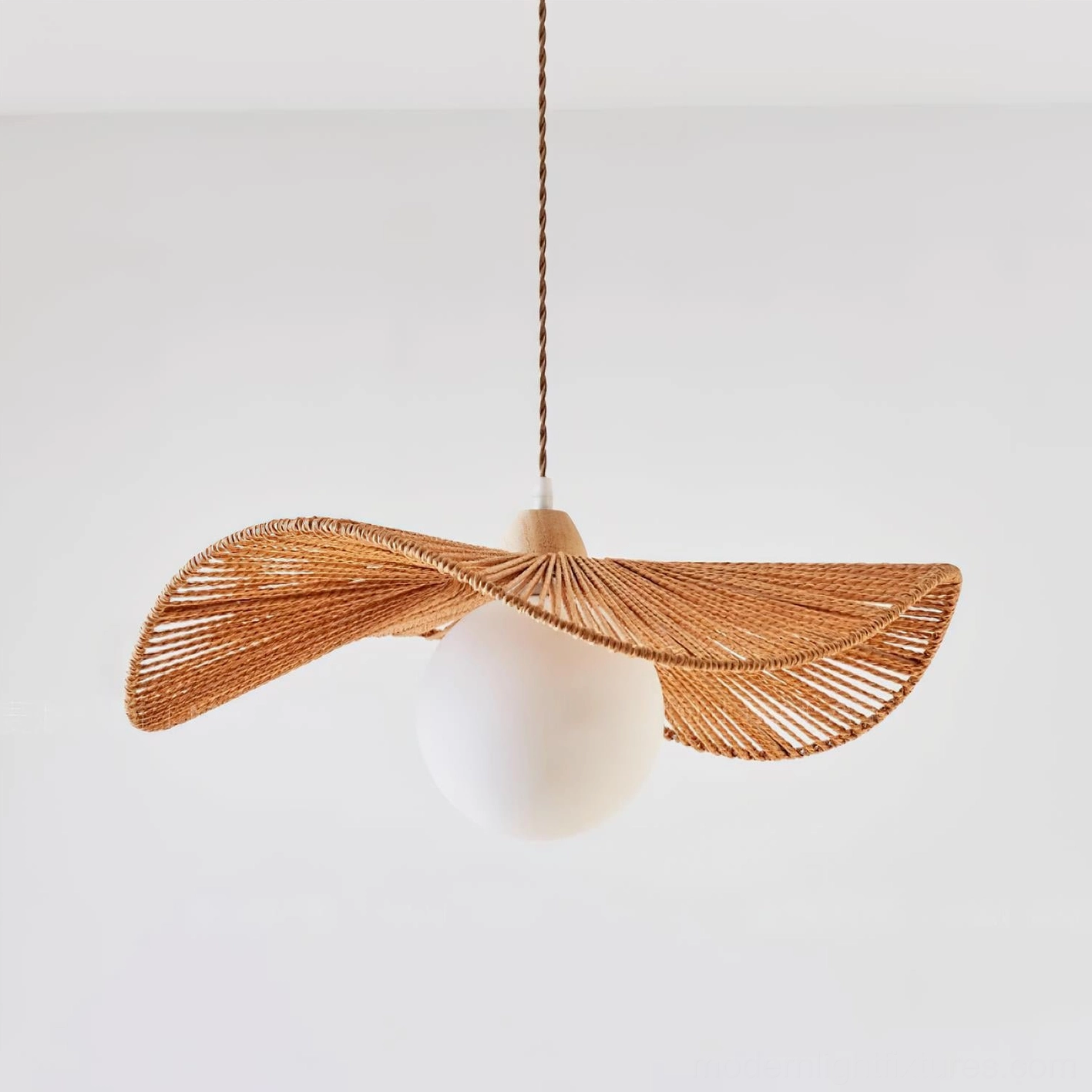 Coastal woven hemp rope hanging lamp in minimalist Scandinavian interior setting