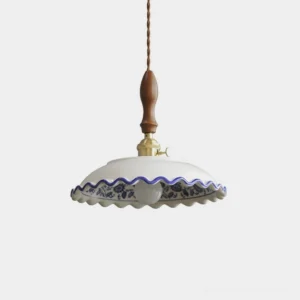 Cobalisse blue and white porcelain pendant light with walnut wood handle and brass socket, shown isolated on white background with scalloped ceramic rim