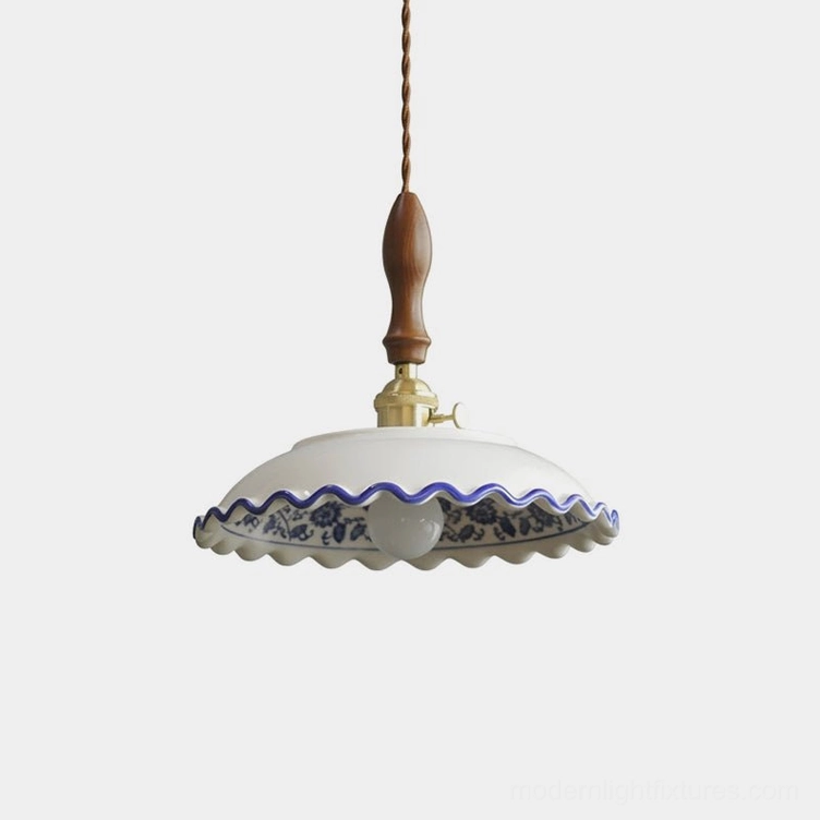 Cobalisse blue and white porcelain pendant light with walnut wood handle and brass socket, shown isolated on white background with scalloped ceramic rim