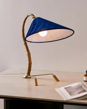 Cobalune bamboo-inspired desk lamp eye-level side view in home workspace with warm exposed bulb lighting