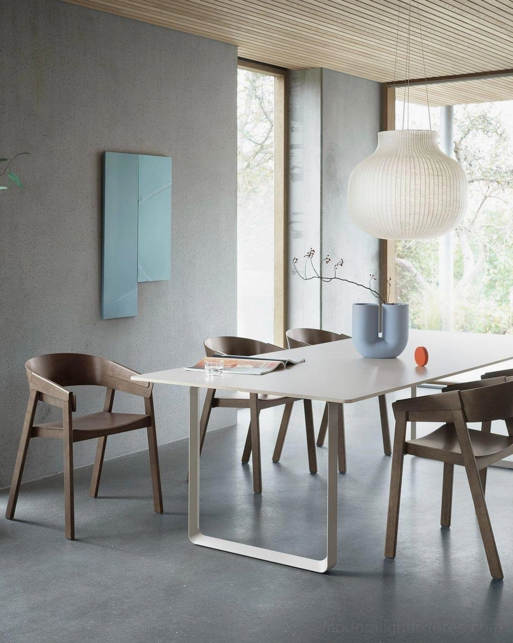 White cocoon pendant light paired with mid-century modern furniture in stylish interior