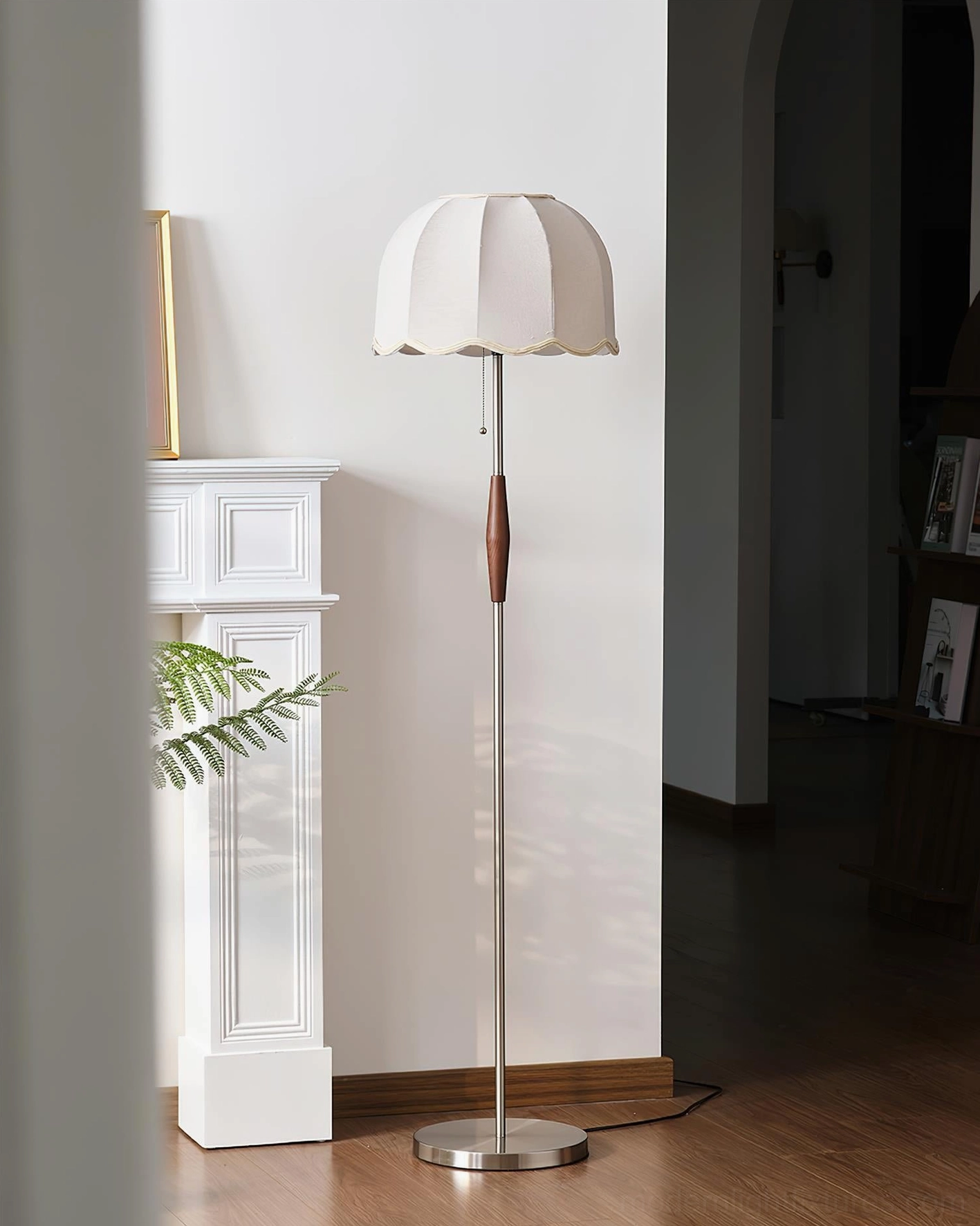 Colette scalloped floor lamp unlit in neutral living room decor with fireplace, minimalist entryway design