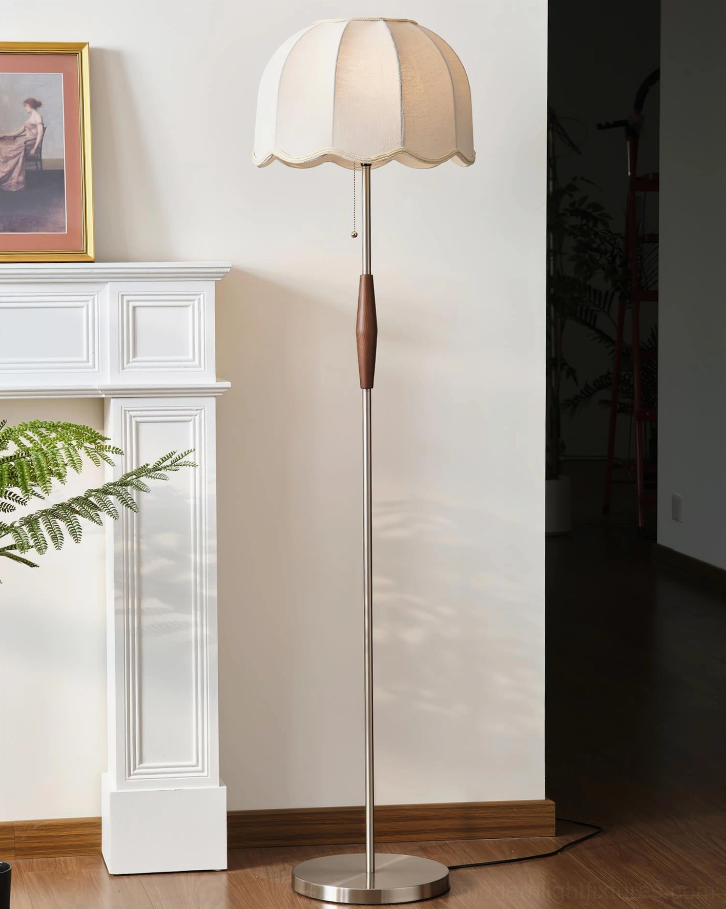 Colette floor lamp in nickel finish with unlit white scalloped shade, right-side full-body view in minimalist living room