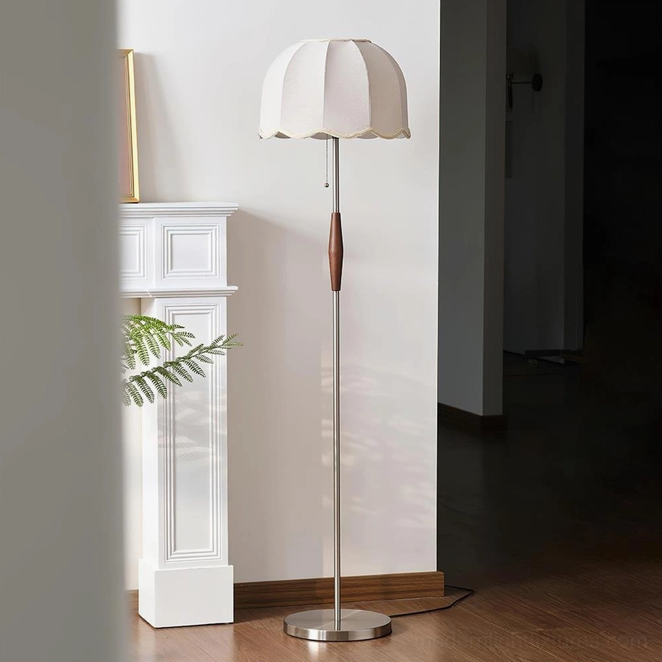 Colette floor lamp in nickel and white finish, side profile showing slender metal pole and walnut wood accent in living room setting