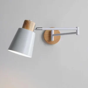 Collin adjustable wall lamp mounted on light gray wall with white swing arm and wood mount accent lighting