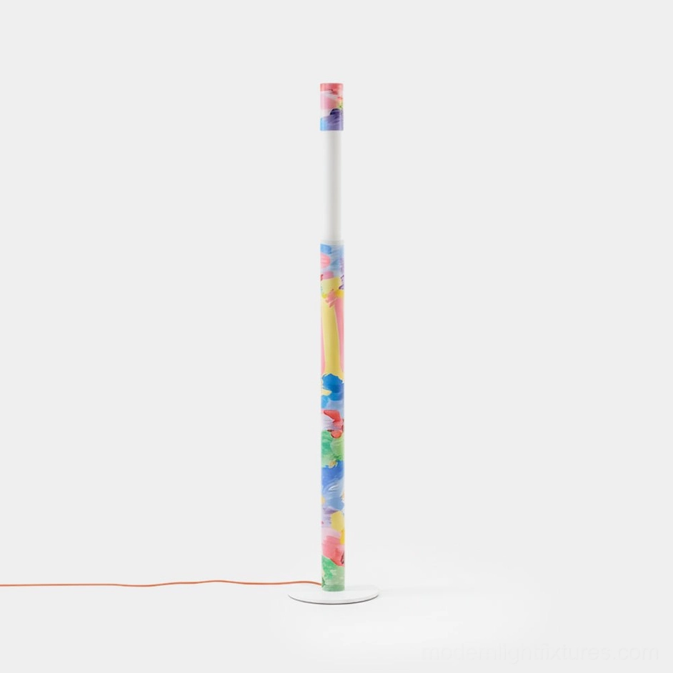 Colorbeam artistic hand-painted floor lamp with multicolor brushstroke design, minimalist white studio backdrop, front view showing cylindrical body and round base