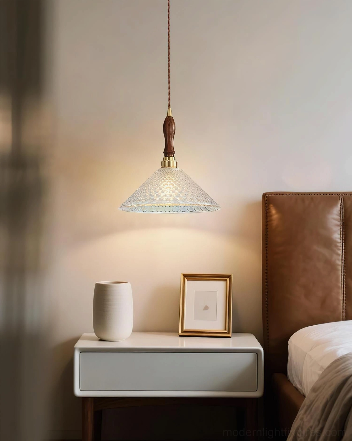 Colored glass pendant lamp with jewel tone blue shade and brass metal components assembly detail